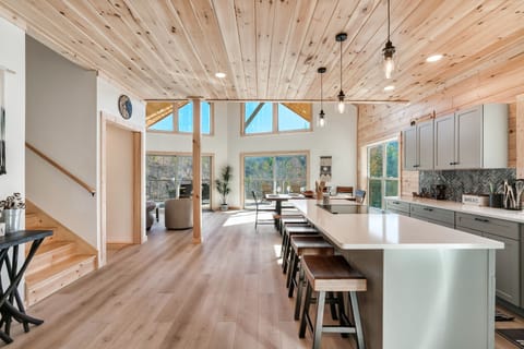 Open fully equipped kitchen with island that accommodates seating for 4