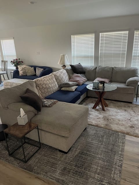 Living room with beautiful rugs and ample pillows and Shaws for comfort