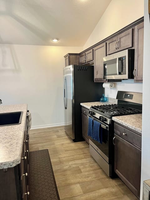 A full kitchen with stainless steel appliances.