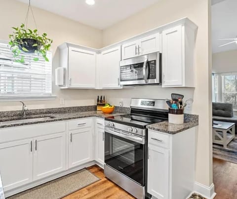 Fully equipped kitchen with granite countertops and stainless steel appliances.
