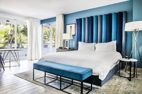 Relax in a serene suite with vibrant accents and soft linens.