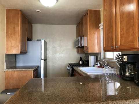 Kitchen is fully equipped with all major appliances including dishwasher