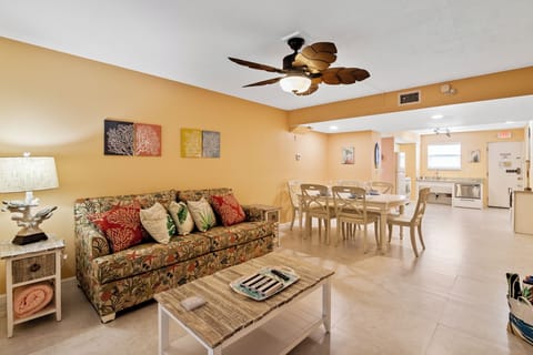 Full living room and dining room with full kitchen in the back.