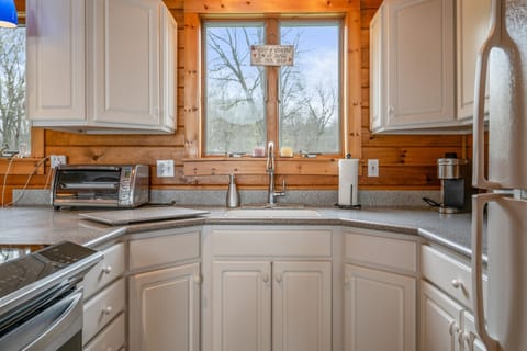 Cozy kitchen with modern appliances and scenic views, perfect for cooking and relaxing.