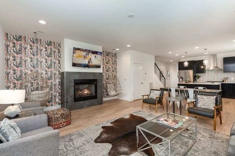 Unit 1: Open-concept living area with cozy furnishings, a Smart TV, and a fireplace.