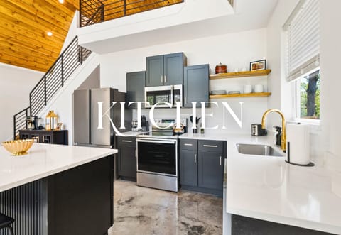 The chef’s kitchen features a farmhouse sink, gold fixtures, and everything you need to whip up something special or keep it super simple.