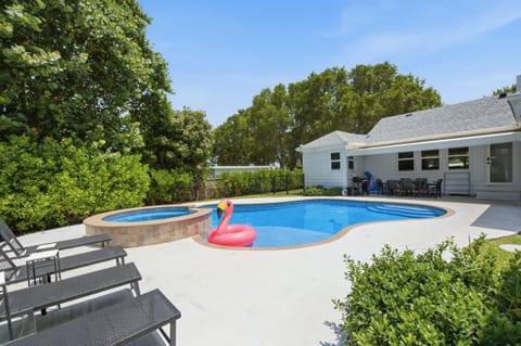 Inviting backyard retreat with a sparkling pool, spa, and covered dining patio.