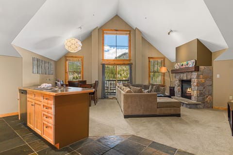 Welcome to your cozy main living area with tons of natural light and mountain views from your private porch