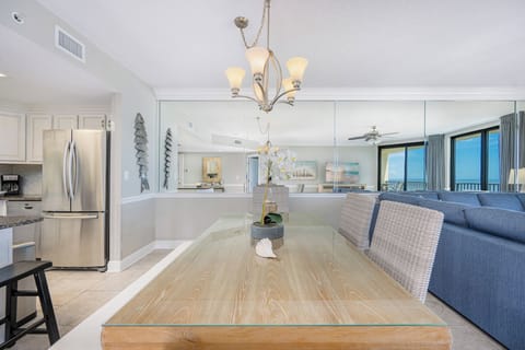 Gather around the elegant dining table, perfect for meals while enjoying the inviting coastal decor and natural light