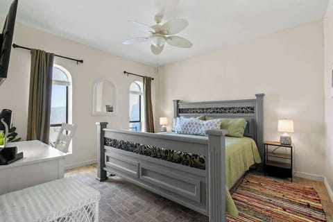 Relax in this inviting bedroom featuring a luxurious king-size bed, charming rustic decor, and plenty of natural light, your perfect retreat after a day of adventure.