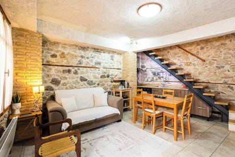 Cozy Open-Plan Living Area with Rustic Stone Walls