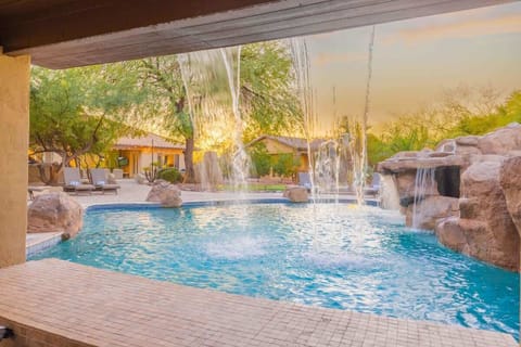 Resort-style pool with rock features—your private desert oasis