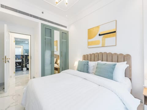 Comfortable bed with a built-in wardrobe featuring sliding doors that open to connect seamlessly with the living room.