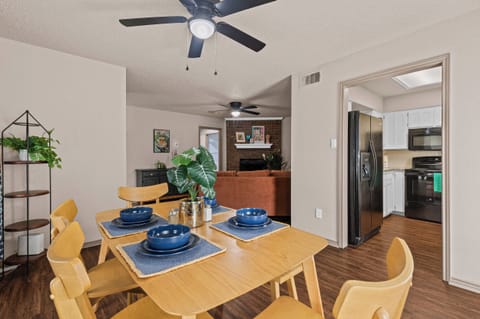Inviting dining area, adjacent to a living room with a fireplace.
