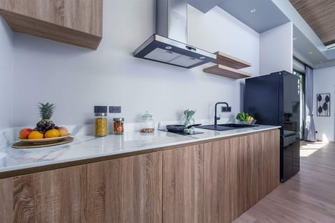 Cook in style in the fully equipped modern kitchen at Aileen Villas Layan. With sleek appliances, ample counter space, and a bright open layout, it's perfect for everything from family meals to tropical breakfast spreads. ️