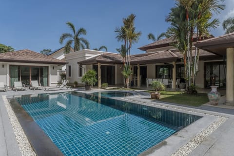 Tropical pool oasis with Jacuzzi, palm shade, and outdoor retreat.