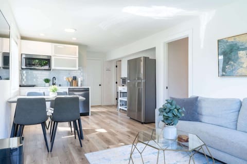 Living room offers a warm, comfortable vibe, enhanced by easy access through the garage door — perfect for everyday ease and coming home moments.