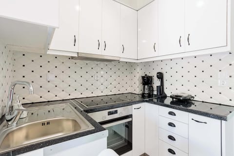 Kitchen Area with Appliances and Storage – Fully equipped for preparing home-cooked meals.