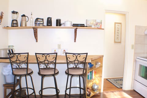 Counter top bar in kitchen with 3 stools