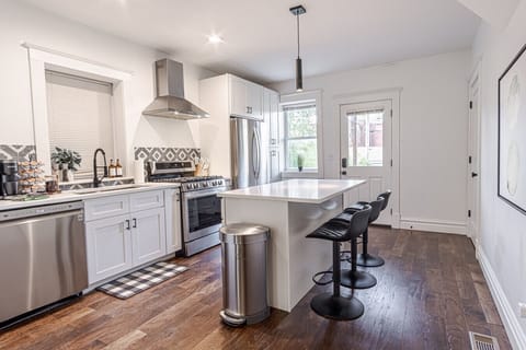 Whip up culinary delights in this modern kitchen with stylish island seating and sunny views!
