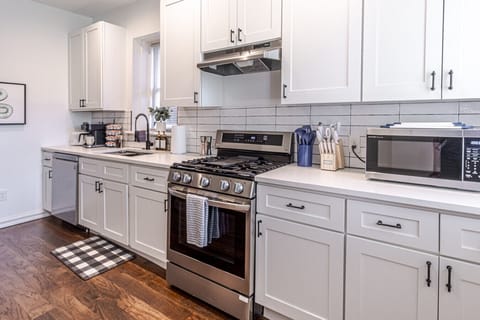 Whip up culinary delights in this stylish kitchen with modern appliances and chic decor.