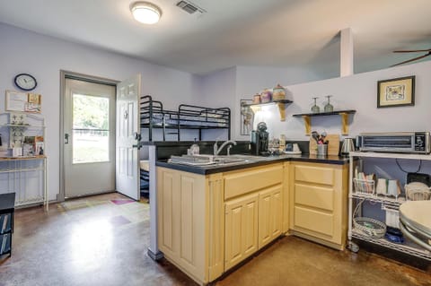Compact kitchenette includes full-size fridge, microwave, Cuisinart toaster oven, and all essentials for simple meal prep.