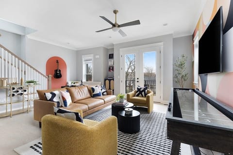 Living room goals - spacious couch and chairs overlooking the record player, dining nook, and terrace.(125 Lucile)