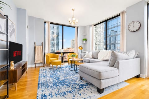 Sunny corner lounge with skyline views, plush sectional, and stylish city charm