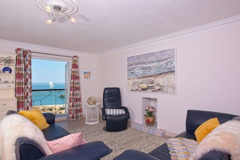 The living room with balcony and stunning sea views