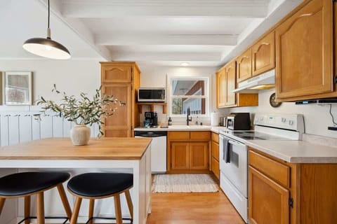 A sunny, fully equipped kitchen, featuring both a standard coffee maker and Keurig, dishwasher, microwave, toaster, and more-perfect for everything from morning pancakes to holiday dinners.