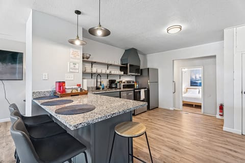 Fully stocked kitchen with granite counters, stainless steel appliances & coffee station—cook like home!