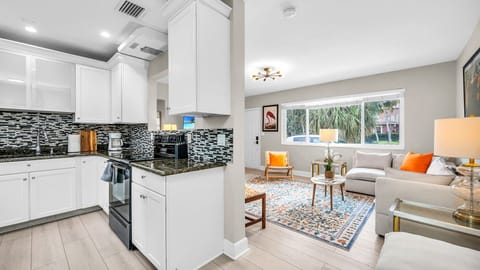 Fully equipped kitchen with granite countertops, a blender, filter coffee machine, and indoor/outdoor tableware for 6. Enjoy easy access to the dining room for effortless entertaining.