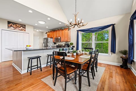 Cook, dine, and unwind in this bright, open kitchen with forest views