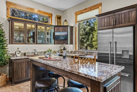 There is another refrigerator here and plenty of glassware. 