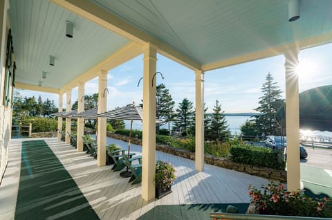 Begin the day with still waters and golden light as you lounge beneath the quiet charm of a wraparound porch.