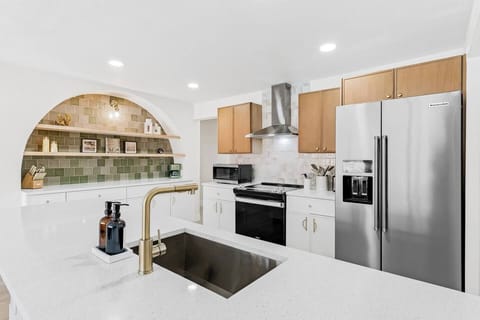 Roomy kitchen with electric stove, dishwasher, and refrigerator.