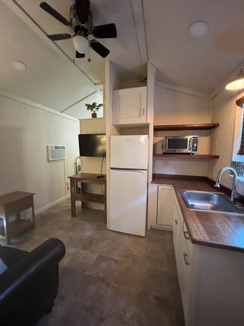 Compact & Functional Kitchen: apartment fridge, microwave, full sink; countertop electric stove, hidden trash can.  Dishes & cooking utensils supplied.  Bring your own air fryer or toaster oven.