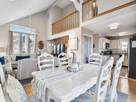 Open-concept dining and living space with beach-inspired decor.