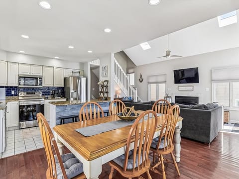 Spacious dining area with a large wooden table, perfect for gathering with family and friends for meals and game nights.
