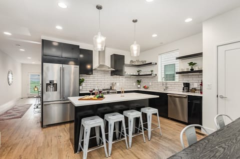 Unit 3: Fully Equipped Kitchen with stainless steal appliances, bar seating, and a dining area.