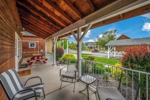 Outside patio with lounge furniture, BBQ, seating, and a sun shade!
