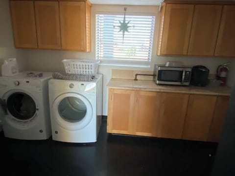 Complete laundry room with washer, dryer, microwave and k-cup machine! 