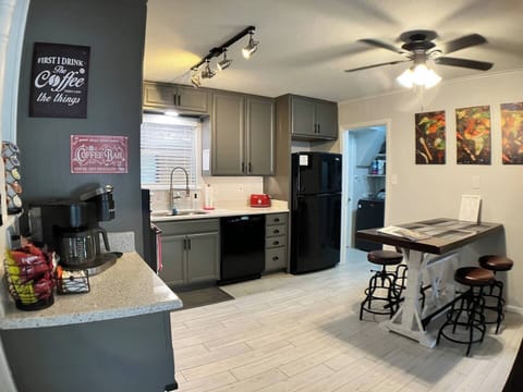 Kitchen with counter-height table and coffee bar.