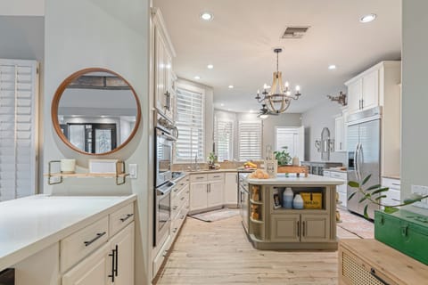 Spacious kitchen featuring a large island, perfect for meal prep and gathering.