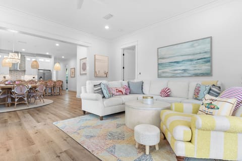 Bright and airy living room with comfortable seating, TV and easy outdoor access.