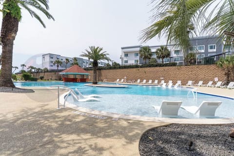 Resort Pool with sun loungers in shallow water