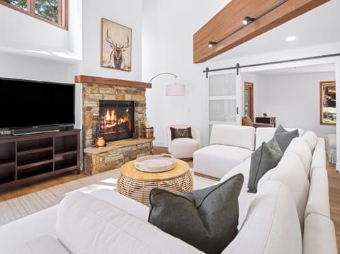 Living room with spacious sectional and cozy fireplace
