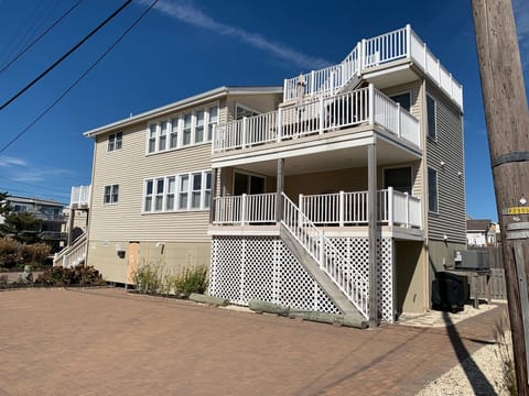 Enjoy the covered deck with steps leading down and to the beach.