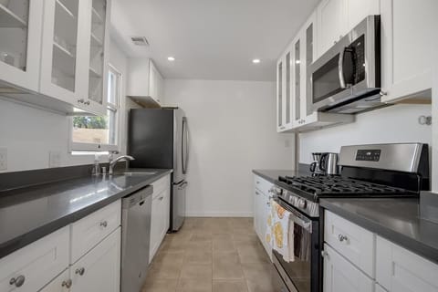 kitchen with gas stove and plenty of counter space and storage.