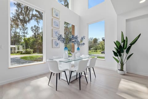 Bright dining space with stunning floor to ceiling windows.
